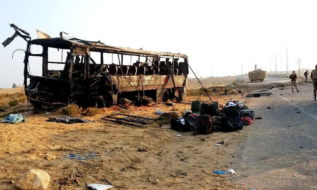 In this imaged released on the official Facebook page of the Egyptian Military Spokesman of the Armed Forces, Egyptian military soldiers inspect the scene near a destroyed bus, after a suicide attacker hit his explosive-laden car into the bus at the road between the border town of Rafah and the coastal city of el-Arish, Egypt, Wednesday, Nov. 20, 2013. A suicide bomber rammed his explosive-laden car into one of two buses carrying off-duty soldiers in Egypt's turbulent region of northern Sinai on Wednesday, killing nearly a dozen and wounding dozens more, security and military officials said. (AP Photo/The Official Facebook Page of the Egyptian Military Spokesman of the Armed Forces)