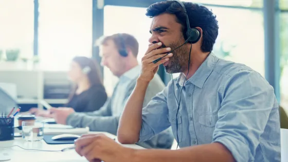 Cropped shot of a call centre agent yawning while working in an office