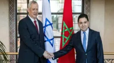 Morocco's Foreign Minister Nasser Bourita (R) shakes hands with Israel's Defence Minister Benny Gantz (L) in the capital Rabat on November 24, 2021. (Photo by FADEL SENNA / AFP) (Photo by FADEL SENNA/AFP via Getty Images)